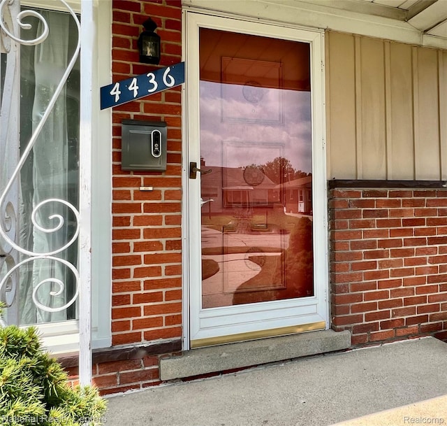 4436 Tulane St, Dearborn Heights, MI 48125 - doorway to property with brick siding and board and batten siding