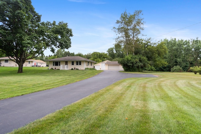 2230 Oleary Rd, Jackson, MI 49201 - ranch-style home with a garage, an outdoor structure, and a front lawn