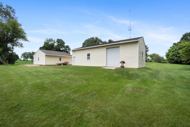 2230 Oleary Rd, Jackson, MI 49201 - rear view of house with a detached garage, an outdoor structure, and a yard