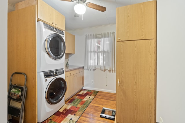 2230 Oleary Rd, Jackson, MI 49201 - washroom with estacked washer and dryer, cabinet space, wood finished floors, and a ceiling fan