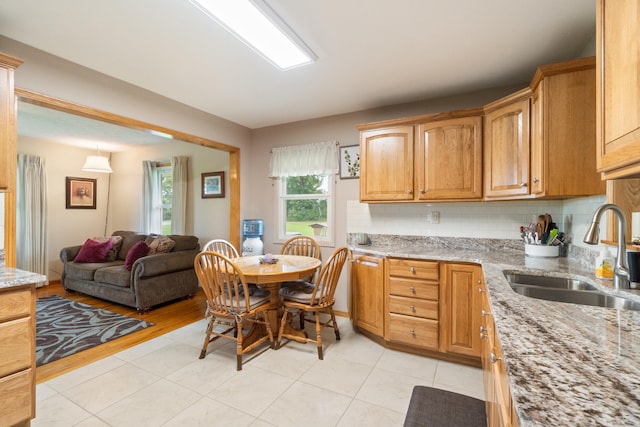 2230 Oleary Rd, Jackson, MI 49201 - kitchen featuring light stone countertops, tasteful backsplash, light tile patterned floors, and open floor plan
