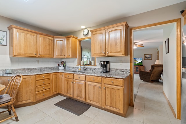 2230 Oleary Rd, Jackson, MI 49201 - kitchen featuring decorative backsplash, light stone countertops, light tile patterned floors, and recessed lighting