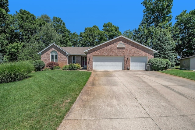 4291 Bramblewood Ct, Dorr, MI 49323 - single story home featuring brick siding, a front yard, driveway, and a garage
