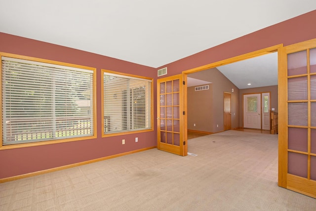4291 Bramblewood Ct, Dorr, MI 49323 - unfurnished room with carpet flooring, french doors, and vaulted ceiling