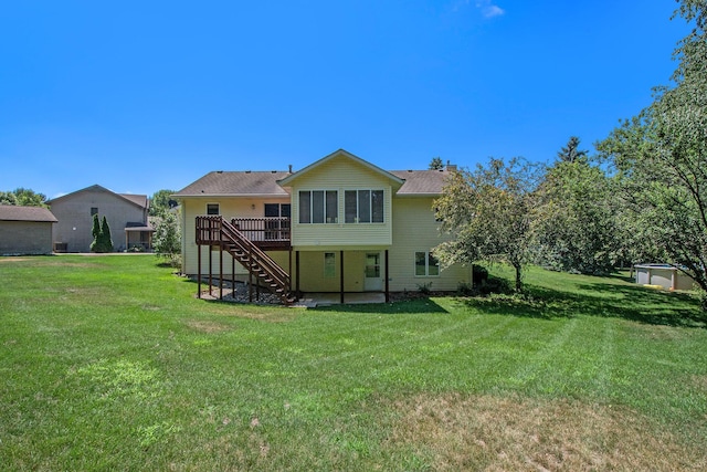 4291 Bramblewood Ct, Dorr, MI 49323 - back of property featuring stairway, a deck, and a lawn