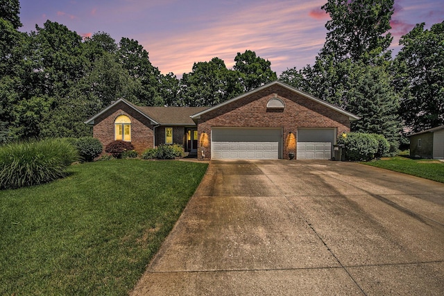 4291 Bramblewood Ct, Dorr, MI 49323 - view of front facade with brick siding, concrete driveway, a lawn, and an attached garage