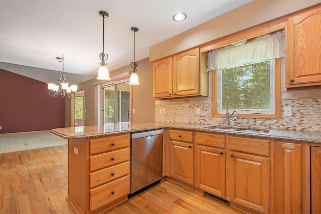 4291 Bramblewood Ct, Dorr, MI 49323 - kitchen featuring stainless steel dishwasher, light wood-style floors, a peninsula, light stone countertops, and backsplash