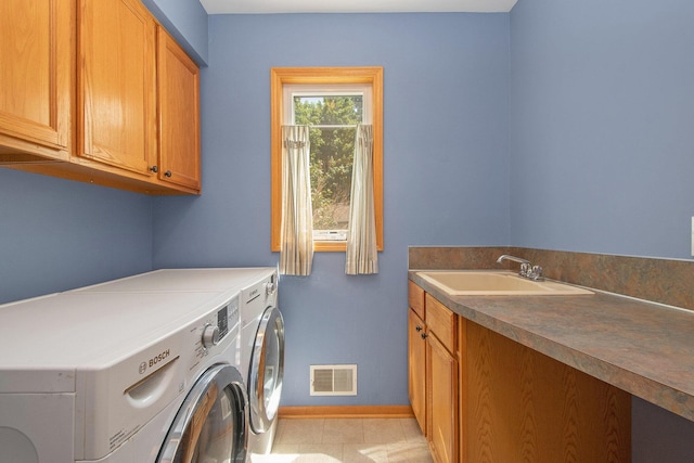 4291 Bramblewood Ct, Dorr, MI 49323 - washroom featuring cabinet space, washer and dryer, and light tile patterned floors