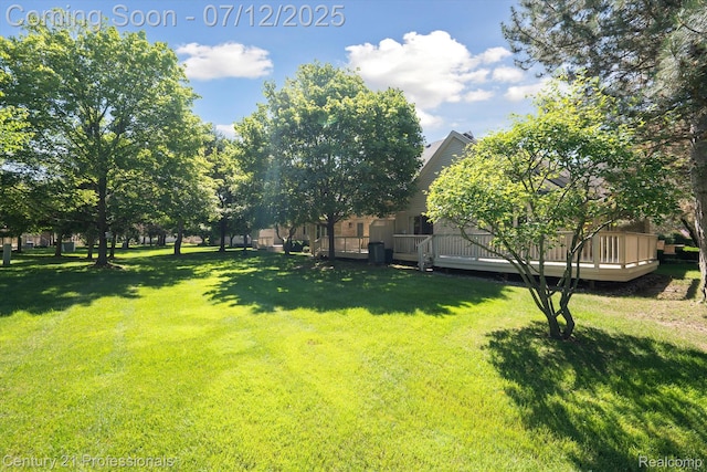 17012 Coral Ln, Macomb, MI 48042 - view of grassy yard with a wooden deck