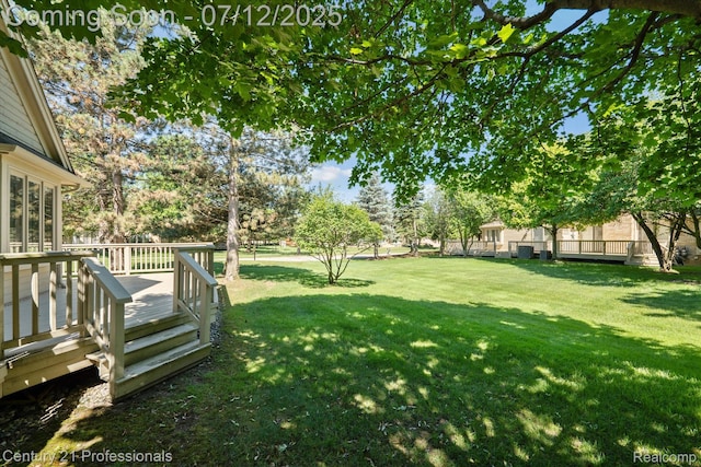 17012 Coral Ln, Macomb, MI 48042 - view of green lawn with a deck