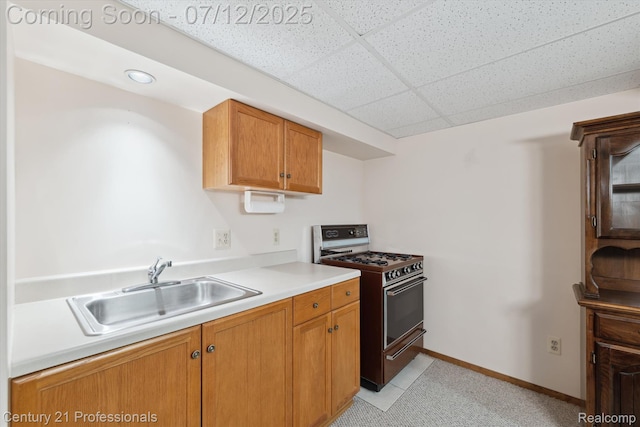 17012 Coral Ln, Macomb, MI 48042 - kitchen with gas stove, a paneled ceiling, light countertops, brown cabinetry, and recessed lighting
