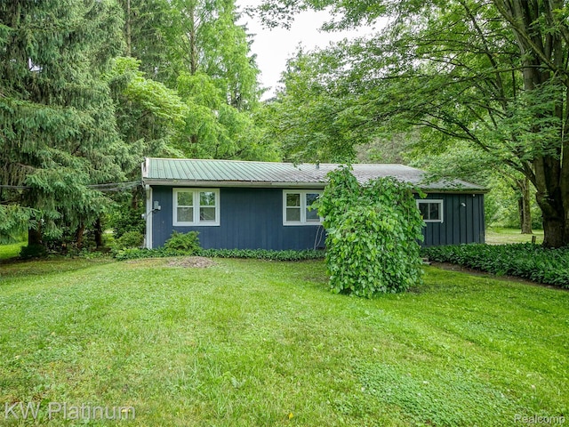 6636 Broadbridge Rd, Cottrellville, MI 48039 - view of front facade with a front lawn and a metal roof