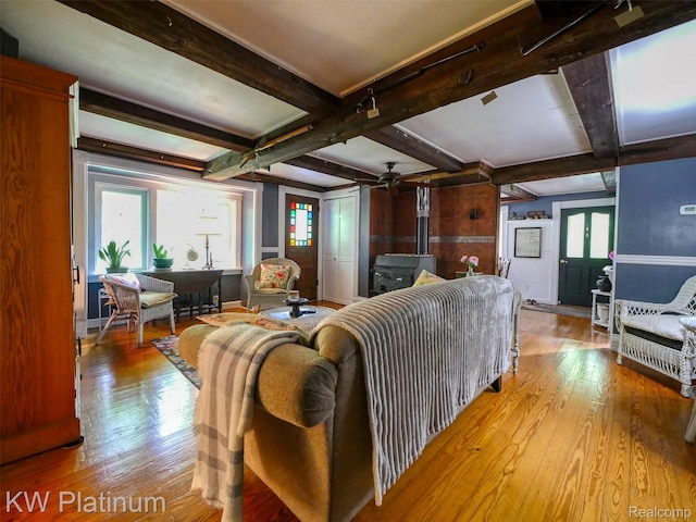 6636 Broadbridge Rd, Cottrellville, MI 48039 - living room with wood-type flooring, a wood stove, and beam ceiling