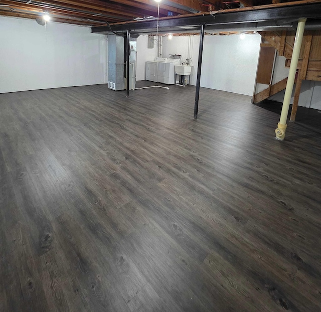 44497 Savery Dr, Canton, MI 48187 - unfinished basement featuring washing machine and clothes dryer, dark wood-style flooring, and stairway