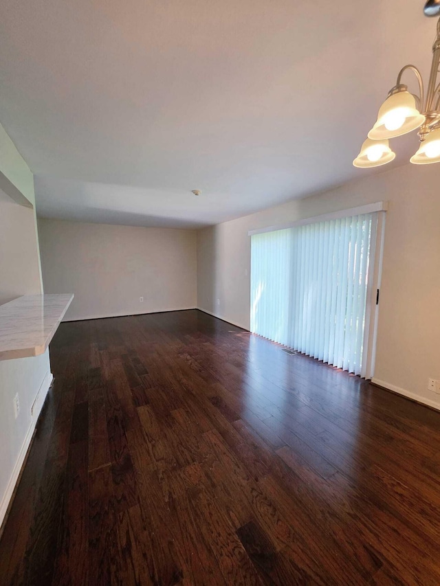 44497 Savery Dr, Canton, MI 48187 - unfurnished living room featuring dark wood finished floors and baseboards