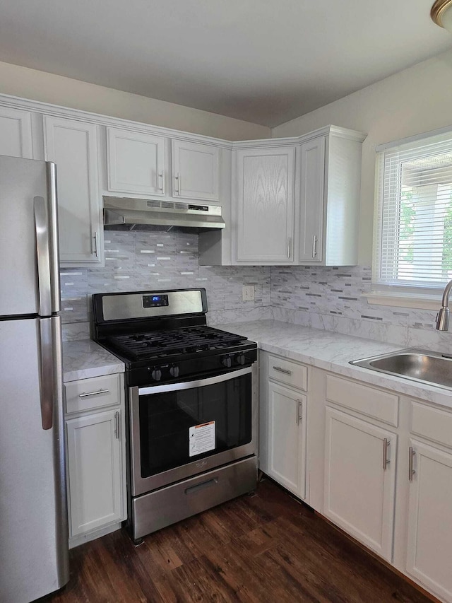 44497 Savery Dr, Canton, MI 48187 - kitchen featuring appliances with stainless steel finishes, under cabinet range hood, white cabinetry, and backsplash