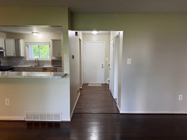 44497 Savery Dr, Canton, MI 48187 - kitchen featuring appliances with stainless steel finishes, light countertops, dark wood-type flooring, tasteful backsplash, and exhaust hood