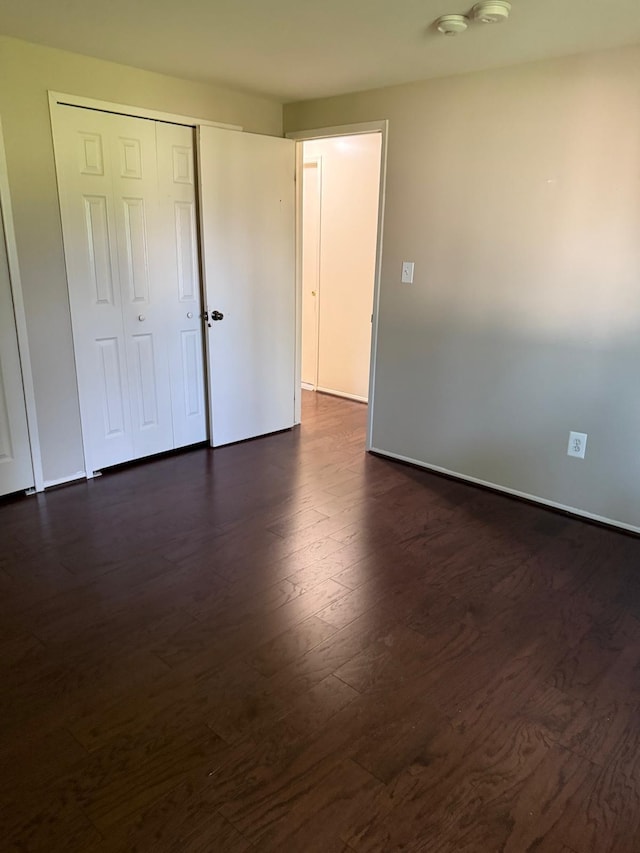 44497 Savery Dr, Canton, MI 48187 - unfurnished bedroom featuring dark wood-style flooring and a closet