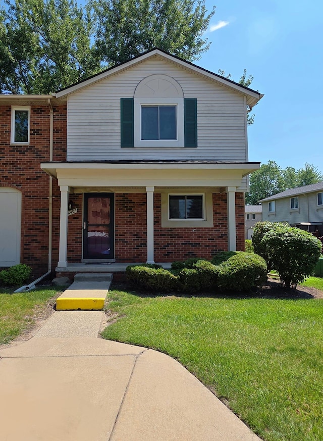 44497 Savery Dr, Canton, MI 48187 - view of front facade featuring brick siding, a porch, and a front yard