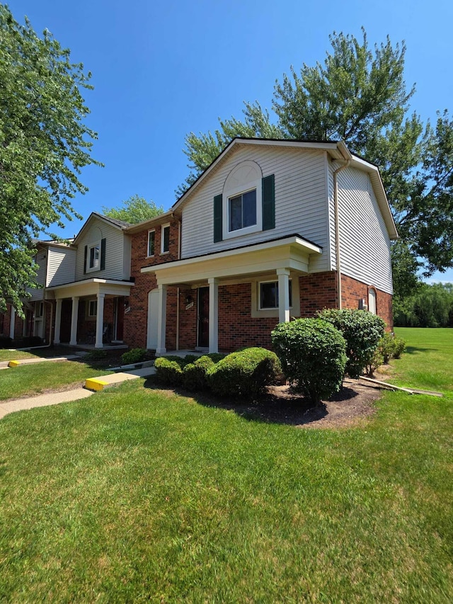 44497 Savery Dr, Canton, MI 48187 - traditional-style home with brick siding and a front lawn