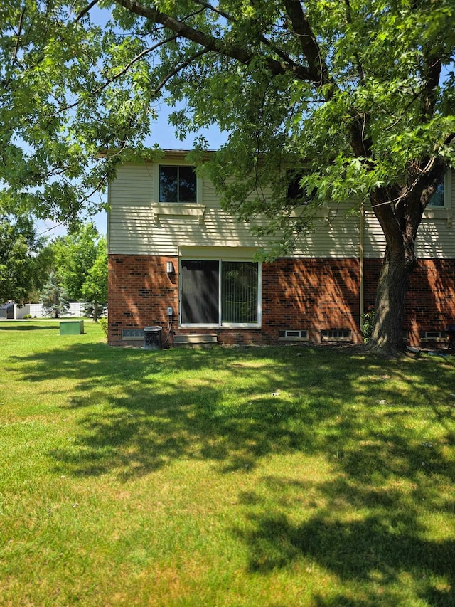 44497 Savery Dr, Canton, MI 48187 - rear view of house with a yard and brick siding