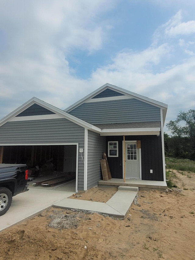 LOT128 Old Farm Dr, Wayland, MI 49348 - view of front of home featuring an attached garage, driveway, covered porch, and roof with shingles