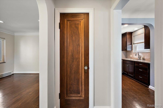 1450 Hampton Rd, Grosse Pointe Woods, MI 48236 - hall featuring arched walkways, dark wood finished floors, and ornamental molding