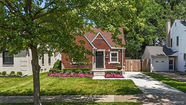 1450 Hampton Rd, Grosse Pointe Woods, MI 48236 - view of front facade featuring brick siding, a front yard, a gate, and driveway
