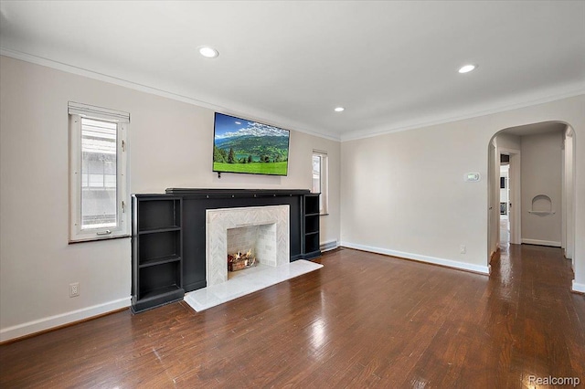 1450 Hampton Rd, Grosse Pointe Woods, MI 48236 - unfurnished living room featuring arched walkways, crown molding, a fireplace, wood finished floors, and recessed lighting