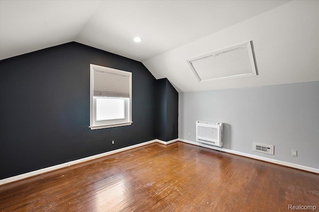 1450 Hampton Rd, Grosse Pointe Woods, MI 48236 - additional living space with heating unit, vaulted ceiling, attic access, and wood finished floors