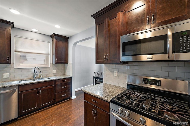 1450 Hampton Rd, Grosse Pointe Woods, MI 48236 - kitchen featuring stainless steel appliances, dark wood-type flooring, light stone counters, decorative backsplash, and recessed lighting