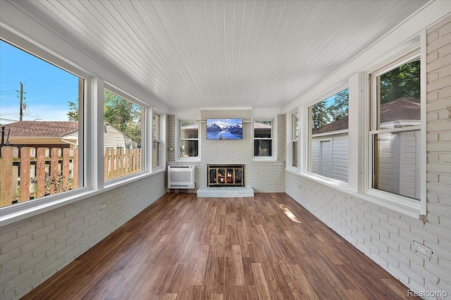 1450 Hampton Rd, Grosse Pointe Woods, MI 48236 - unfurnished sunroom featuring brick wall, an AC wall unit, plenty of natural light, and wood finished floors