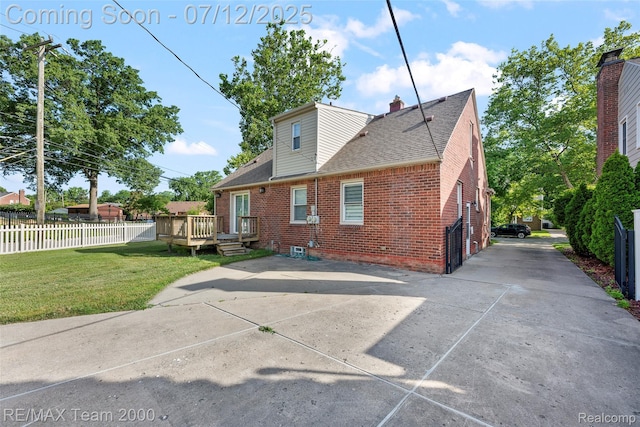 23167 Cromwell St, Canton, MI 48128 - back of property featuring brick siding, a deck, and a shingled roof