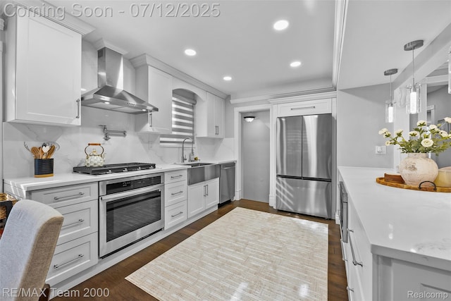 23167 Cromwell St, Canton, MI 48128 - kitchen featuring appliances with stainless steel finishes, wall chimney range hood, white cabinets, light countertops, and recessed lighting