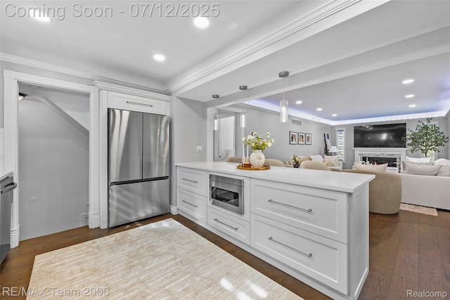 23167 Cromwell St, Canton, MI 48128 - kitchen with stainless steel appliances, white cabinetry, a warm lit fireplace, recessed lighting, and light countertops
