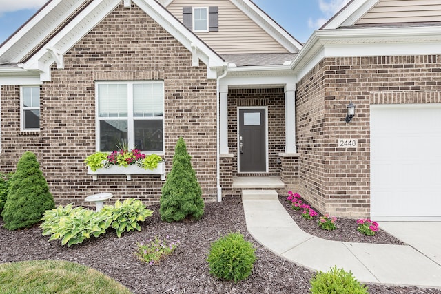 2448 Meadow Hills Dr, Ann Arbor, MI 48108 - view of exterior entry featuring brick siding and an attached garage