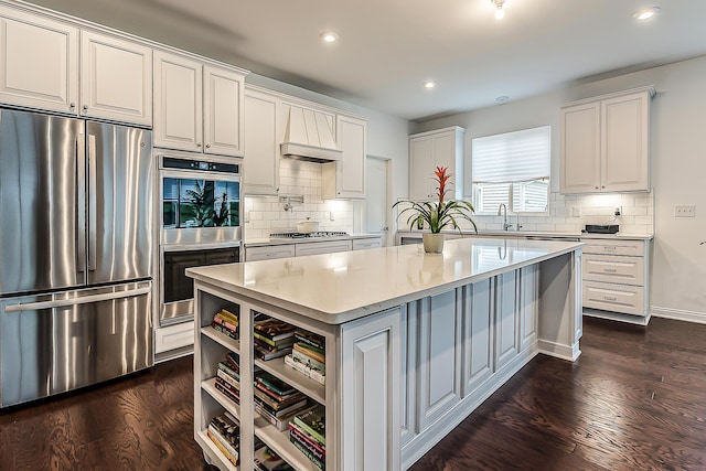 2448 Meadow Hills Dr, Ann Arbor, MI 48108 - kitchen with stainless steel appliances, a kitchen island, light countertops, recessed lighting, and white cabinets