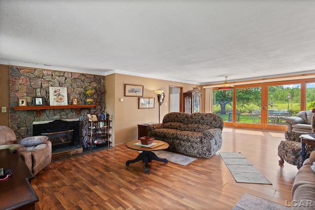753 Vaniman Island Dr, Brooklyn, MI 49230 - living area with wood finished floors, a fireplace, and crown molding