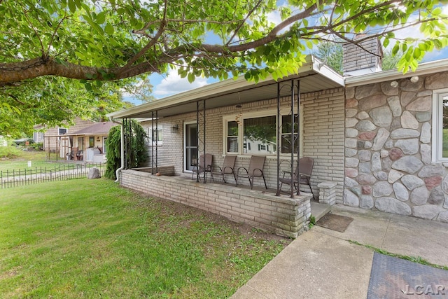 753 Vaniman Island Dr, Brooklyn, MI 49230 - doorway to property with covered porch, brick siding, and stone siding