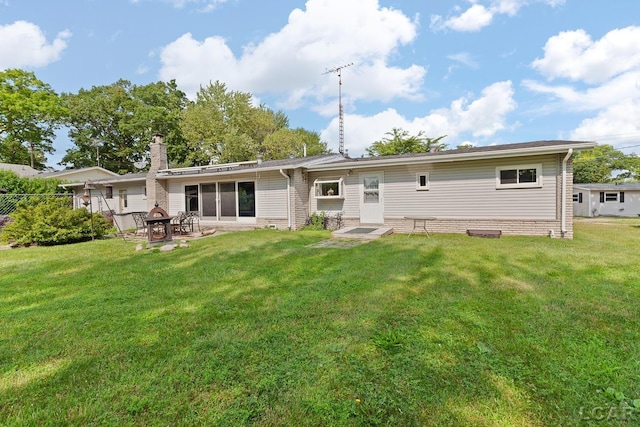 753 Vaniman Island Dr, Brooklyn, MI 49230 - rear view of house with a lawn, a patio area, and a chimney