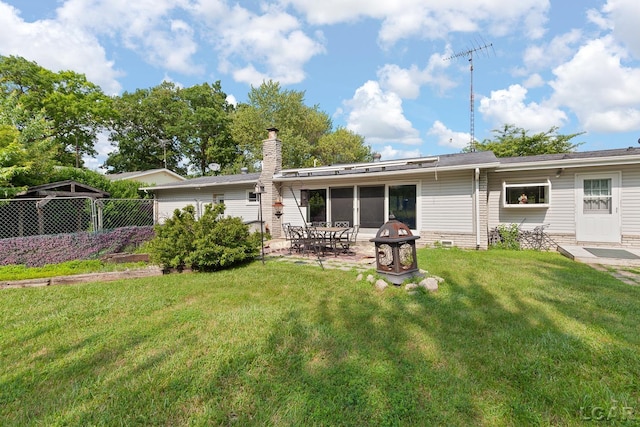 753 Vaniman Island Dr, Brooklyn, MI 49230 - rear view of house with a patio and a chimney