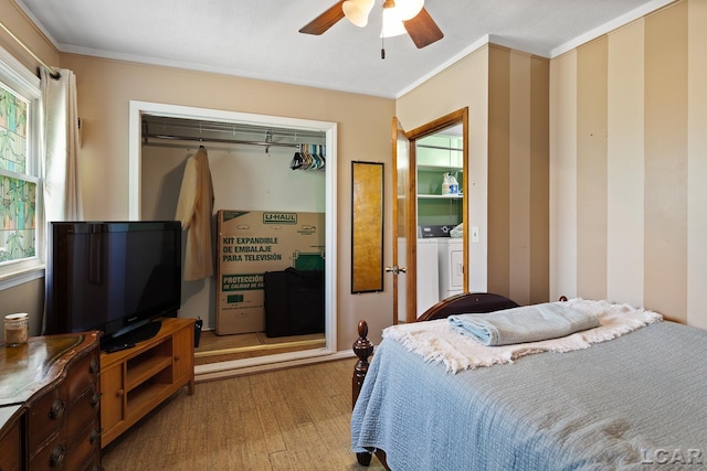 753 Vaniman Island Dr, Brooklyn, MI 49230 - bedroom featuring washer and clothes dryer, light wood-style floors, crown molding, multiple windows, and a ceiling fan