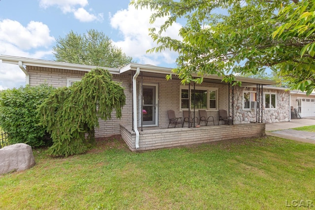 753 Vaniman Island Dr, Brooklyn, MI 49230 - ranch-style home with a porch, a front lawn, an attached garage, and concrete driveway