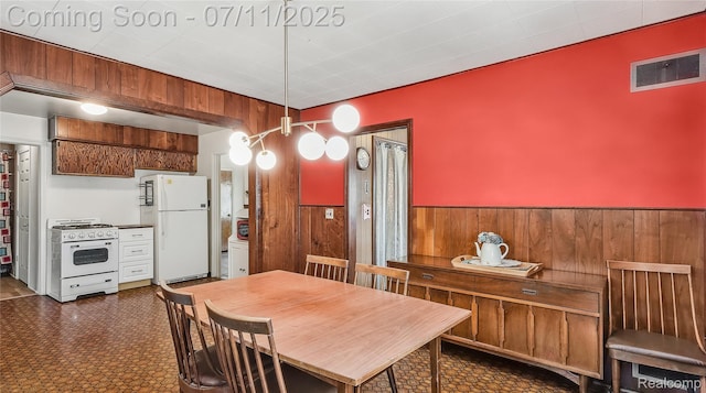 1845 Van Courtland Dr, Troy, MI 48083 - dining area with wood walls, a wainscoted wall, and dark floors