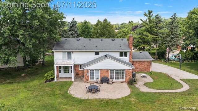 2403 Red Maple Ct, Troy, MI 48098 - back of house featuring a patio area, a lawn, a chimney, and a balcony
