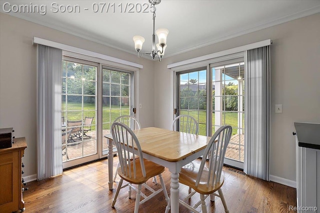 2403 Red Maple Ct, Troy, MI 48098 - dining area featuring a chandelier, crown molding, and light wood-style floors