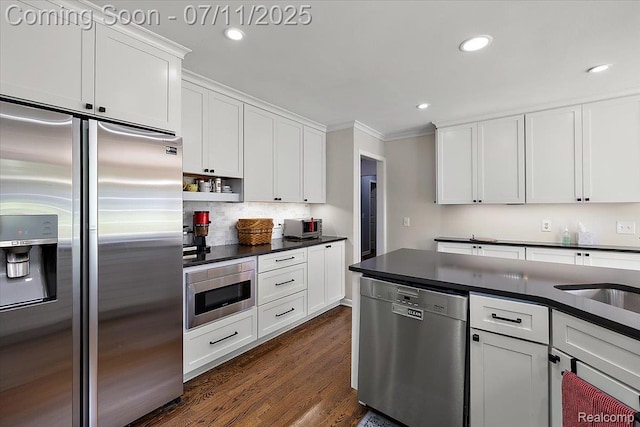 2403 Red Maple Ct, Troy, MI 48098 - kitchen with appliances with stainless steel finishes, dark countertops, crown molding, white cabinets, and dark wood finished floors