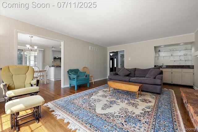 2403 Red Maple Ct, Troy, MI 48098 - living room with wood finished floors, a chandelier, and bar area