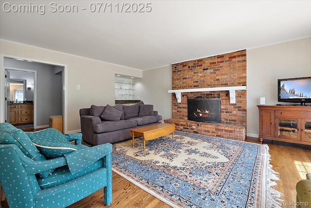 2403 Red Maple Ct, Troy, MI 48098 - living room with wood finished floors, crown molding, and a fireplace