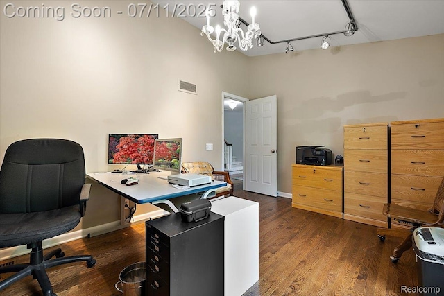 2403 Red Maple Ct, Troy, MI 48098 - home office featuring wood finished floors, rail lighting, a towering ceiling, and a chandelier